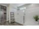 Modern bathroom with tiled shower, built-in bench, glass enclosure, and open shelving for a spa-like experience at 38082 W Santa Barbara Ave, Maricopa, AZ 85138