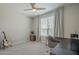 Cozy bedroom with a ceiling fan, a window with blinds, and a desk at 38082 W Santa Barbara Ave, Maricopa, AZ 85138