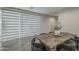 Dining area featuring sheer shades and an open layout that seamlessly connects to the living area at 38082 W Santa Barbara Ave, Maricopa, AZ 85138