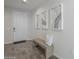 Inviting entryway with tiled floors, a bench, and artwork, creating a welcoming atmosphere for guests at 38082 W Santa Barbara Ave, Maricopa, AZ 85138
