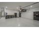 Large garage with work area, storage cabinets, and utility hookups at 38082 W Santa Barbara Ave, Maricopa, AZ 85138