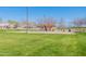 Expansive green space area featuring playground and covered picnic area for Gathering fun and community activities at 38082 W Santa Barbara Ave, Maricopa, AZ 85138