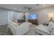Cozy living room features neutral tones, stylish decor, and plenty of natural light at 38082 W Santa Barbara Ave, Maricopa, AZ 85138