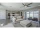 Inviting living room connects to a modern kitchen, featuring a comfortable sofa and pool views at 38082 W Santa Barbara Ave, Maricopa, AZ 85138
