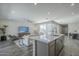 Open concept living space features a large island, modern cabinets, and comfortable seating area at 38082 W Santa Barbara Ave, Maricopa, AZ 85138