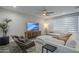 Bright living room boasts stylish furniture, a decorative entertainment center, and contemporary design at 38082 W Santa Barbara Ave, Maricopa, AZ 85138