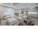 Open concept living and kitchen space with modern cabinets, an island, and plenty of seating at 38082 W Santa Barbara Ave, Maricopa, AZ 85138