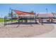 A playground features swings, a slide, and a covered picnic area for outdoor fun at 38082 W Santa Barbara Ave, Maricopa, AZ 85138