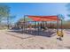 Community playground featuring swings and climbing structures for outdoor play and recreation at 38082 W Santa Barbara Ave, Maricopa, AZ 85138
