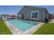 Inviting pool with fountain features, lounge area, and lush artificial turf, perfect for outdoor relaxation at 38082 W Santa Barbara Ave, Maricopa, AZ 85138