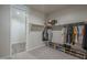 Spacious walk-in closet with shelving and hanging racks, great storage capacity at 38082 W Santa Barbara Ave, Maricopa, AZ 85138