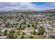 High-definition aerial view of the neighborhood with well-maintained homes, lush greenery, and a scenic mountain range at 3834 E Clarendon Ave, Phoenix, AZ 85018