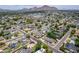 Stunning aerial view of the property showcasing neighborhood, mature trees, and a beautiful mountain backdrop at 3834 E Clarendon Ave, Phoenix, AZ 85018