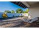 Outdoor seating on a patio overlooking a backyard with desert landscaping at 3834 E Clarendon Ave, Phoenix, AZ 85018