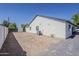 Large backyard, partially graveled, showing the exterior of the home and the yard's potential at 3834 E Clarendon Ave, Phoenix, AZ 85018