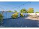 The backyard is accented by desert landscaping and surrounded by a white privacy fence at 3834 E Clarendon Ave, Phoenix, AZ 85018