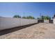 Backyard with a tall block fence and wood gate, creating a secluded outdoor area at 3834 E Clarendon Ave, Phoenix, AZ 85018