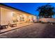 Large backyard with patio, lounge chairs, outdoor seating, and sliding glass doors to the home's interior at 3834 E Clarendon Ave, Phoenix, AZ 85018