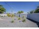 Spacious backyard with desert plants, offering a private outdoor space, bordered by a block wall at 3834 E Clarendon Ave, Phoenix, AZ 85018