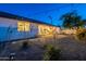 Charming backyard with patio, seating, drought-tolerant landscaping, and string lights for evening ambiance at 3834 E Clarendon Ave, Phoenix, AZ 85018