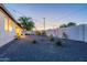 Expansive backyard featuring a covered patio area with seating, native landscaping, and plenty of open space at 3834 E Clarendon Ave, Phoenix, AZ 85018