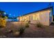 Lovely backyard with native plants, a covered patio, and ample space for relaxing or entertaining at 3834 E Clarendon Ave, Phoenix, AZ 85018