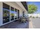 Covered patio with dining area, gravel groundcover, and decorative trees for outdoor entertaining at 3834 E Clarendon Ave, Phoenix, AZ 85018