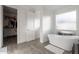 Bright bathroom featuring a freestanding tub, wood floors and a walk-in closet at 3834 E Clarendon Ave, Phoenix, AZ 85018