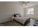 Bedroom featuring a ceiling fan, a window, neutral paint and decor, and wood-look floors at 3834 E Clarendon Ave, Phoenix, AZ 85018