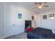 Bedroom with white trim, fan, wood-look floors, and flat screen TV in a modern interior design at 3834 E Clarendon Ave, Phoenix, AZ 85018