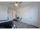 This bedroom has a ceiling fan, modern wood-look floors and white walls, with two doors visible at 3834 E Clarendon Ave, Phoenix, AZ 85018