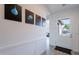 Hallway featuring modern art, leading to a well lit front door and front yard at 3834 E Clarendon Ave, Phoenix, AZ 85018