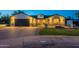 Beautiful exterior view of a single-story home featuring brick accents, a well-manicured lawn, and a spacious driveway at 3834 E Clarendon Ave, Phoenix, AZ 85018