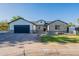 Charming home with a paved driveway, brick accents, and a well-manicured front yard at 3834 E Clarendon Ave, Phoenix, AZ 85018