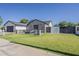 An inviting green lawn and stylish fence enhance the curb appeal of this charming home at 3834 E Clarendon Ave, Phoenix, AZ 85018