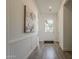 Bright entryway featuring wainscoting and wood-look tile floors at 3834 E Clarendon Ave, Phoenix, AZ 85018