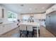 Bright white kitchen with a large center island, stainless steel appliances, and ample counter space at 3834 E Clarendon Ave, Phoenix, AZ 85018