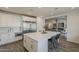 Spacious kitchen with a large center island, stainless steel appliances, and an open layout to the living room at 3834 E Clarendon Ave, Phoenix, AZ 85018