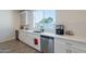 Kitchen with white cabinets, stainless steel appliances, and a view of the backyard from the window at 3834 E Clarendon Ave, Phoenix, AZ 85018