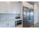 Modern kitchen with stainless steel refrigerator, white cabinetry, and a built-in microwave at 3834 E Clarendon Ave, Phoenix, AZ 85018