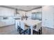 Modern kitchen with white cabinets, stainless steel appliances, and a large island with seating at 3834 E Clarendon Ave, Phoenix, AZ 85018