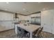 Modern kitchen with an oversized island, stainless steel appliances, white cabinets, and recessed lighting at 3834 E Clarendon Ave, Phoenix, AZ 85018