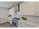 The kitchen features white cabinets, stainless steel appliances, quartz countertops, and ample counter space at 3834 E Clarendon Ave, Phoenix, AZ 85018