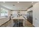 Bright kitchen features stainless steel appliances, a large island with seating, and ample cabinet space at 3834 E Clarendon Ave, Phoenix, AZ 85018