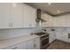 Well-equipped kitchen boasts white cabinets, stainless steel appliances, and quartz countertops at 3834 E Clarendon Ave, Phoenix, AZ 85018