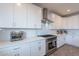 Bright white kitchen with stainless steel appliances, subway tile backsplash, and sleek cabinetry at 3834 E Clarendon Ave, Phoenix, AZ 85018