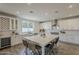 Gourmet kitchen with an island, stainless steel appliances, white cabinets, and plenty of counter space at 3834 E Clarendon Ave, Phoenix, AZ 85018