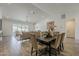 Open-concept living and dining area with modern decor, wood-look floors, and lots of natural light at 3834 E Clarendon Ave, Phoenix, AZ 85018