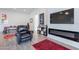 Living room featuring an electric fireplace, TV, and comfortable seating at 3834 E Clarendon Ave, Phoenix, AZ 85018