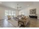Bright living room features a ceiling fan, stylish furnishings, and sliding glass doors to the outside at 3834 E Clarendon Ave, Phoenix, AZ 85018